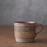 Mostly stacking cup in Shino orange and lines