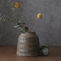 Grey and brown vase with carved marks