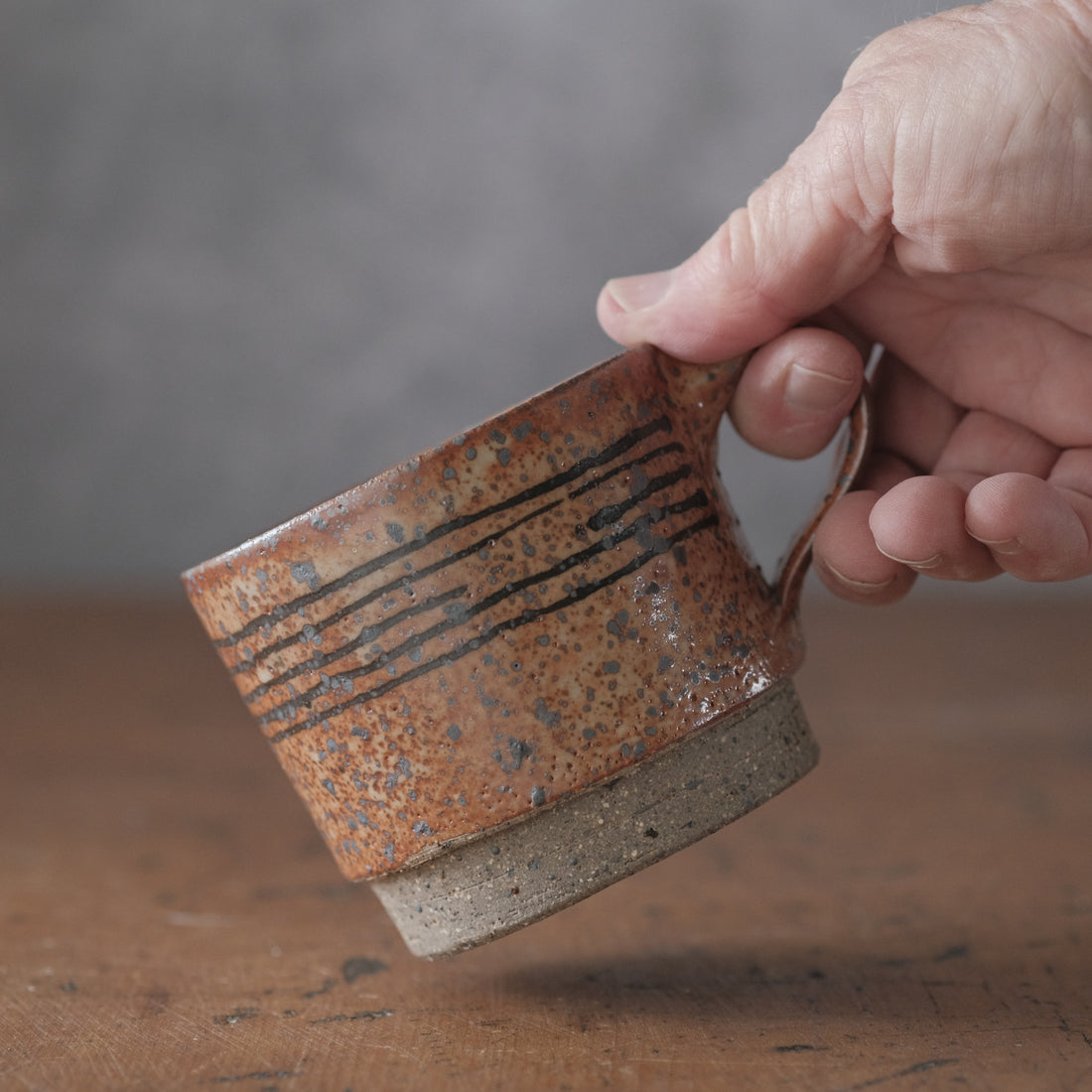 Mostly stacking cup in Shino orange and lines