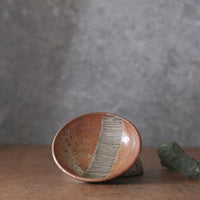 Small Dish with lines and shino orange glaze