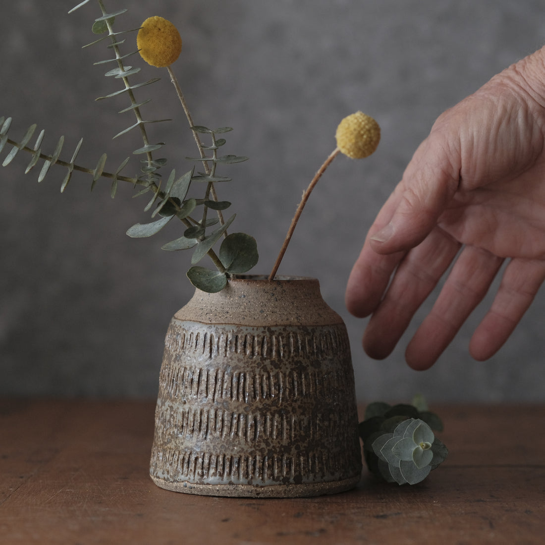 Grey and brown vase with carved marks